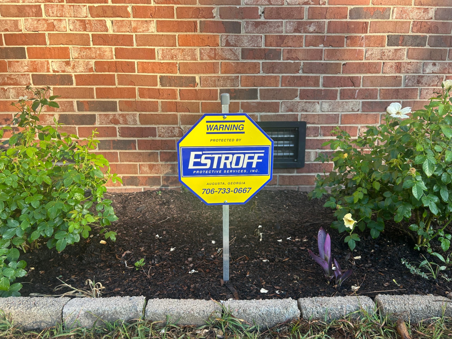 Estroff Protective Services yard sign in front of a brick home in Augusta, Georgia